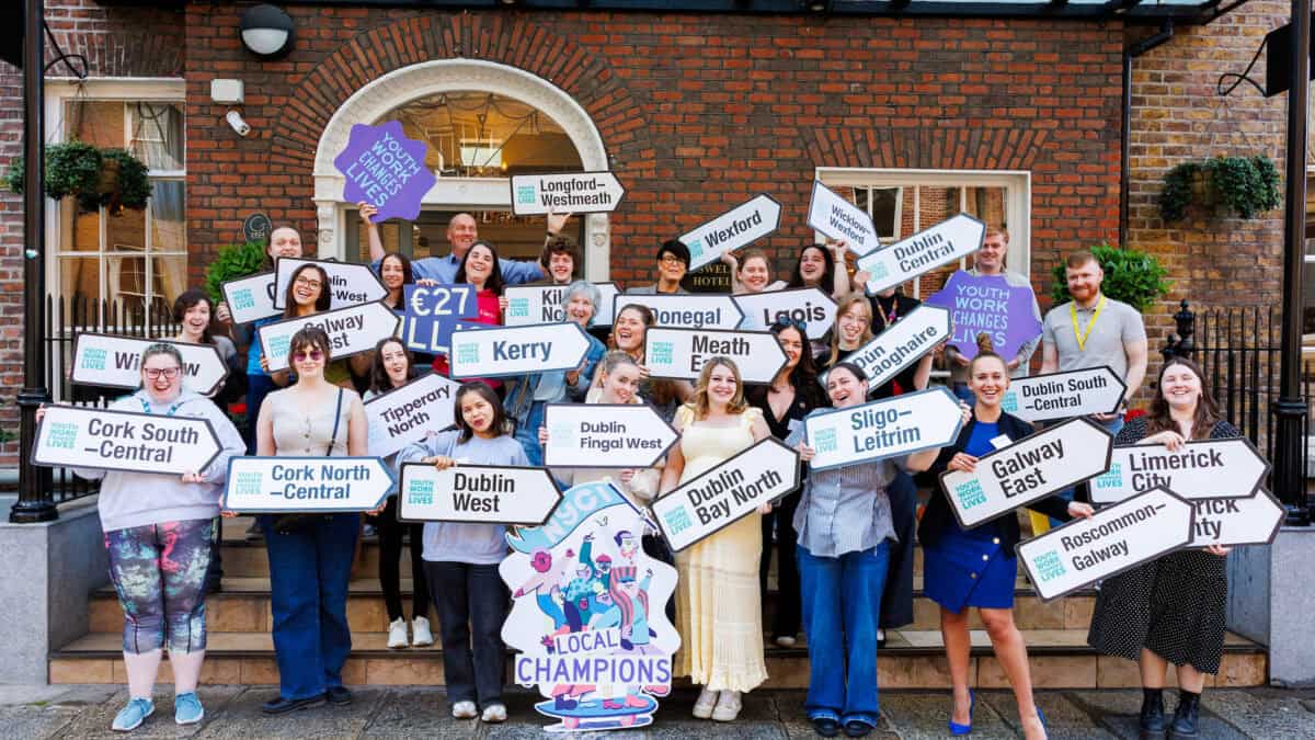 Group of young people holding up signs with names of constituencies, standing outside Buswells Hotel, Dublin.